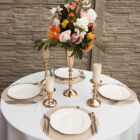 Tischdekoration mit goldenen Kerzenstaendern